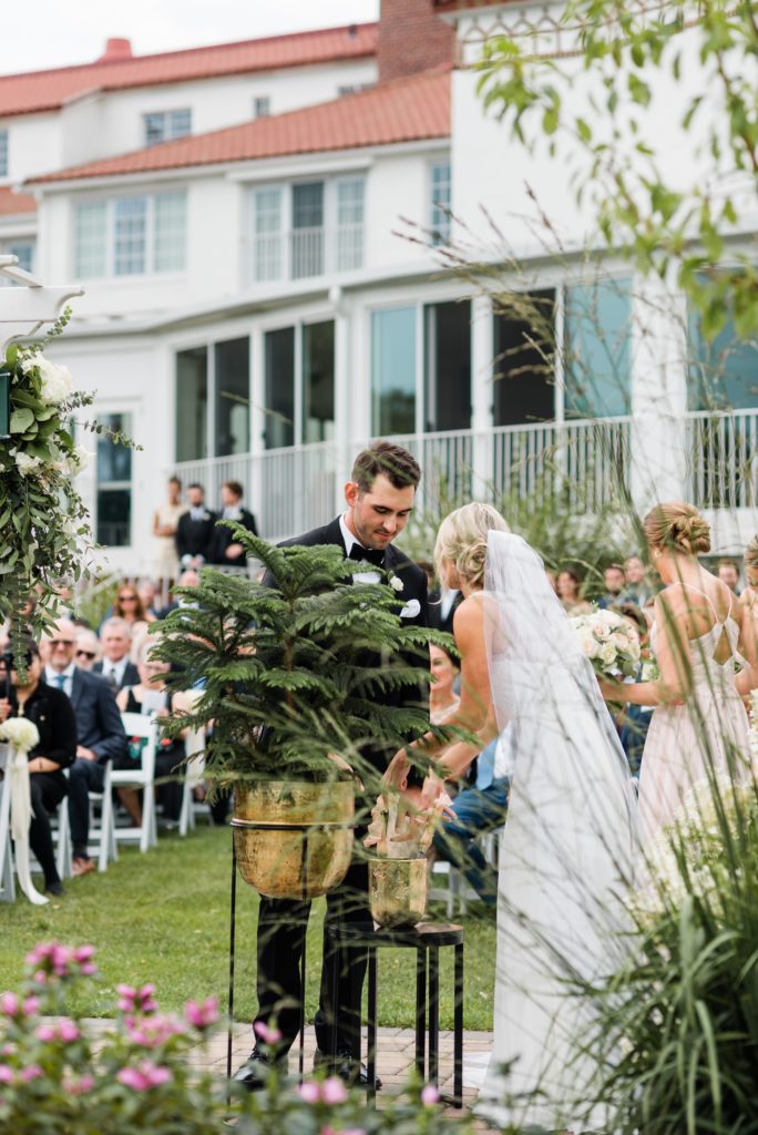 Bride and groom pouring dirt in the unity tree.