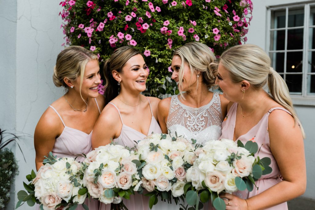 Bride smiling with her bridesmaids.