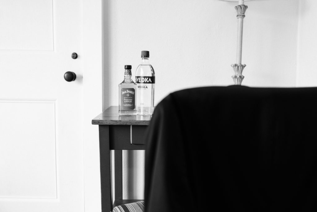 Jack Daniels and Svedka bottles on table.