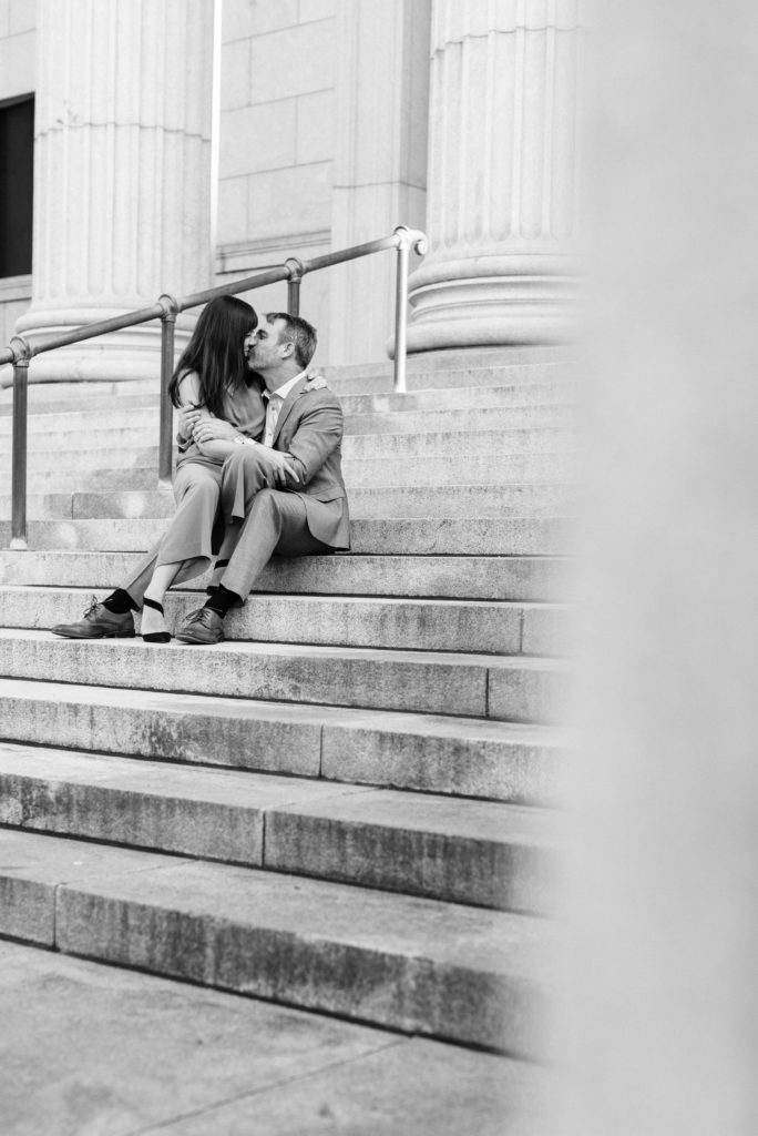 Couple kissing on the stairs of the Minneapolis Institute of Art.
