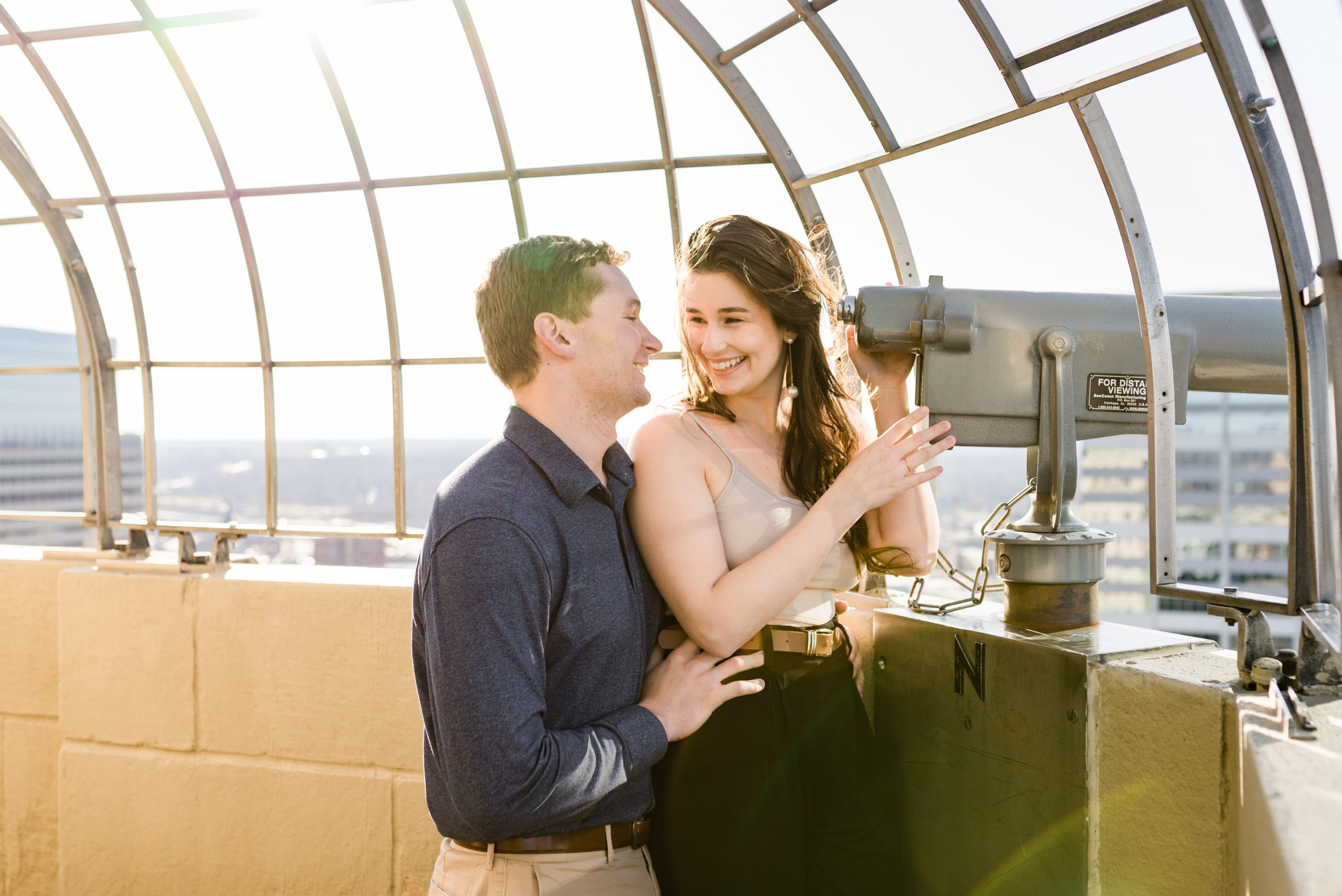 Couple smiling at sunset at the Foshay Tower Observation Deck.