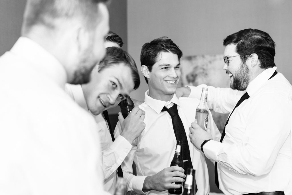 The groomsmen laughing with the groom.
