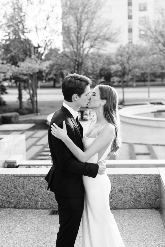 The bride and groom kissing outside the Metropolitan Ballroom & Clubroom.