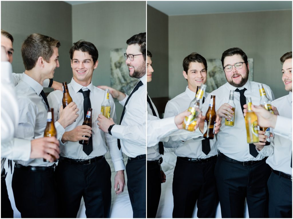 The groomsmen gathered around the groom with beers and giving speeches. 