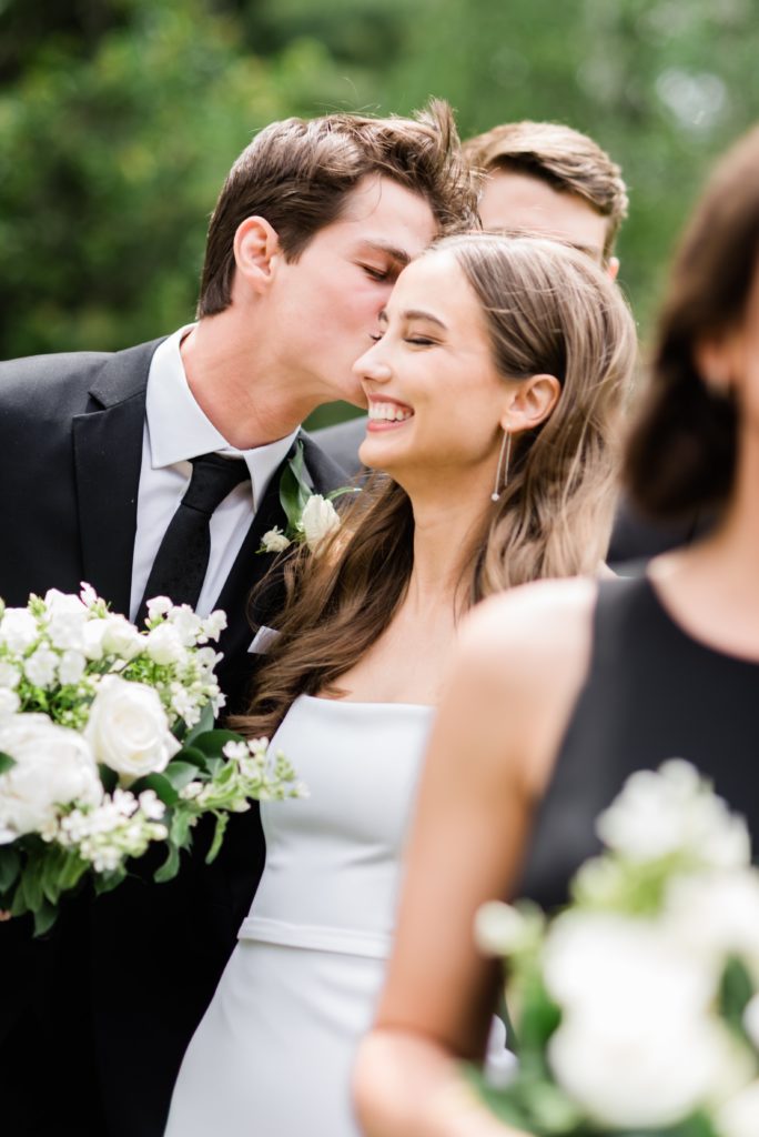 The groom kissing the bride's cheek while walking | SARAH and LUKE Gretchen Yell Photography