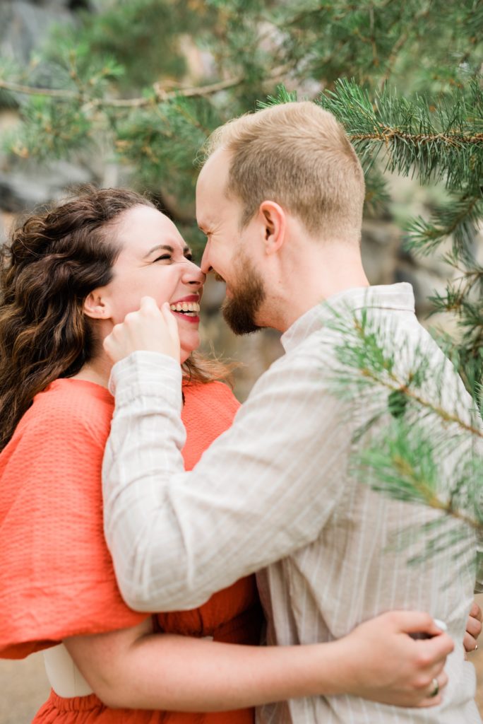 Couple giggling in the trees.
