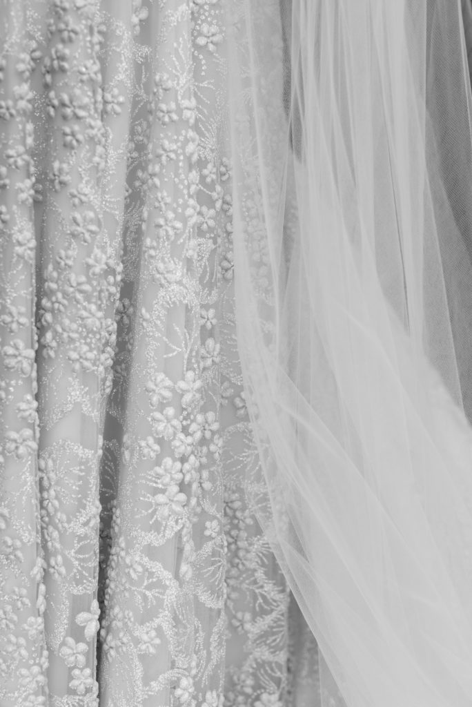Detail of the bride's dress in black and white.