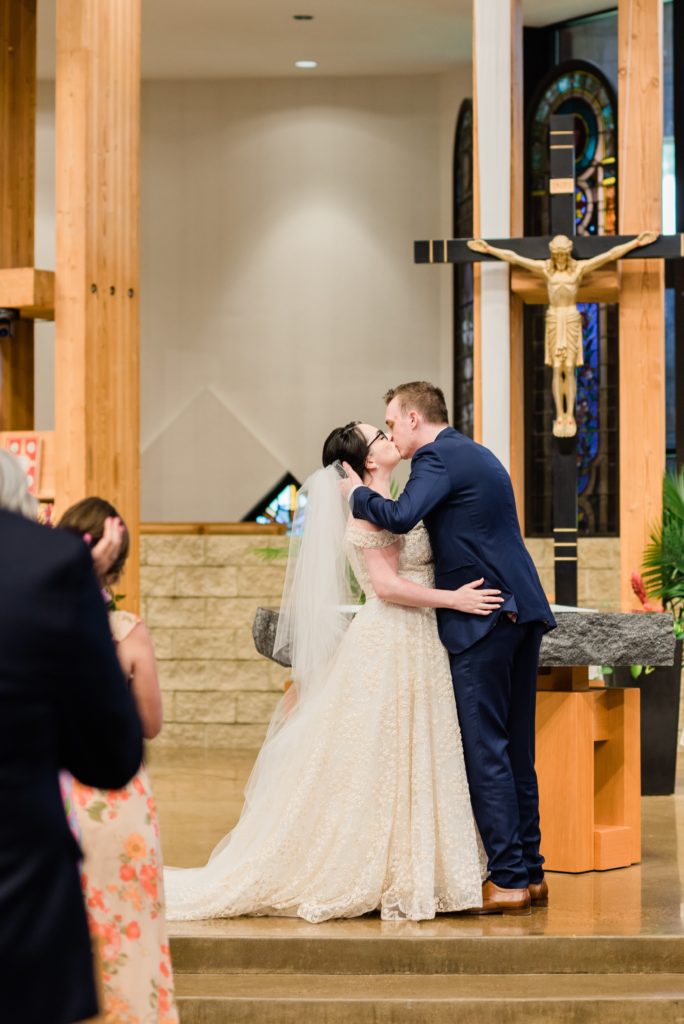 Bride and groom's first kiss at Saint Patrick church, Hudson, WI.