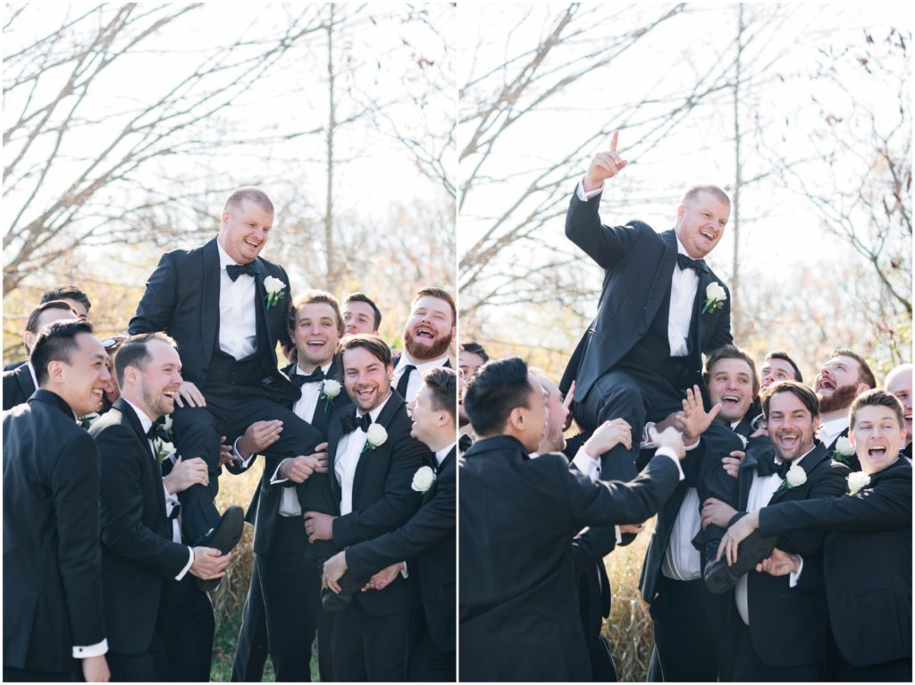 Groomsmen holding up the groom.