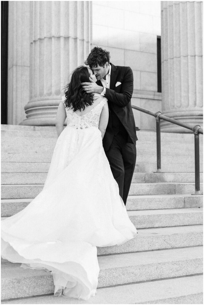 Bride and groom passionately kiss outside the Minneapolis Institute of Art.