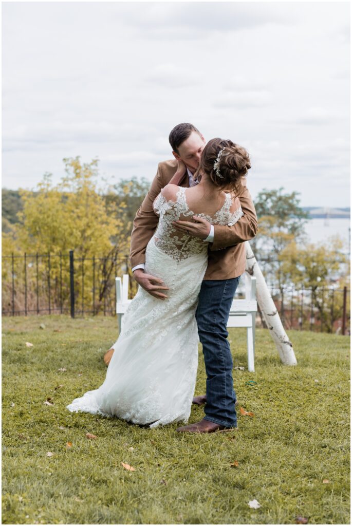The first kiss with bride and groom at Pioneer Park, Stillwater, MN.