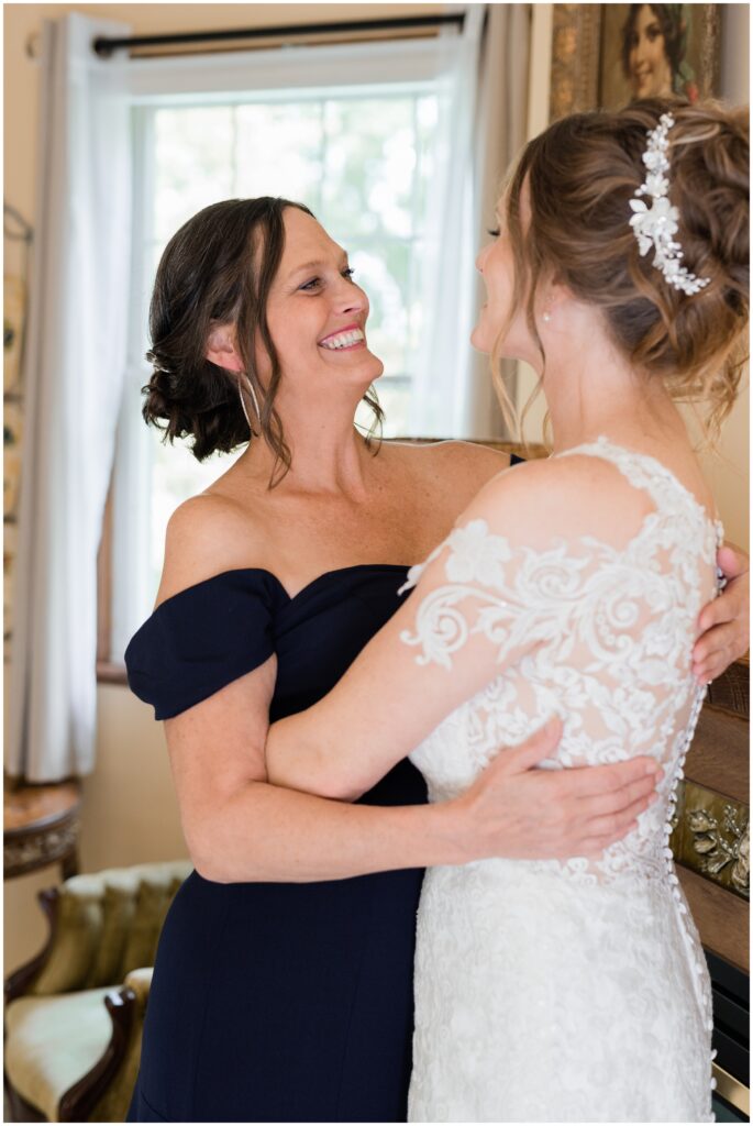 Bride and Mother of the Bride hug at James Mulvey Inn. 
