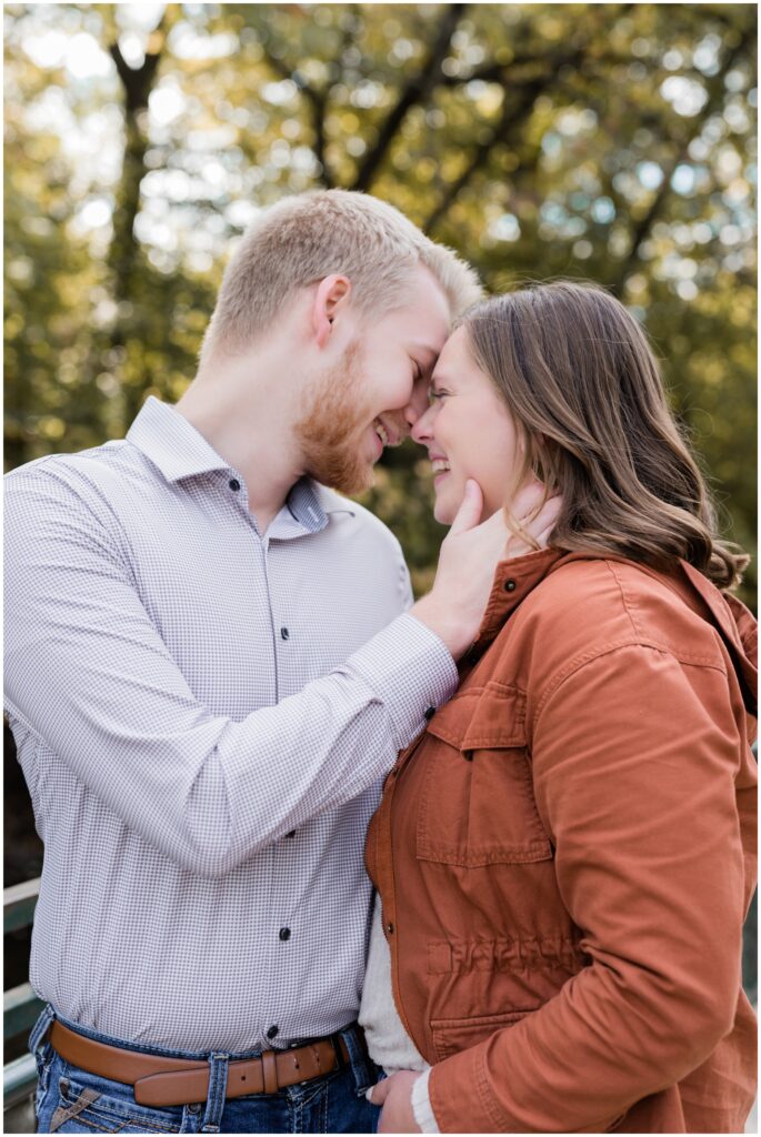Couple touching foreheads while smiling.