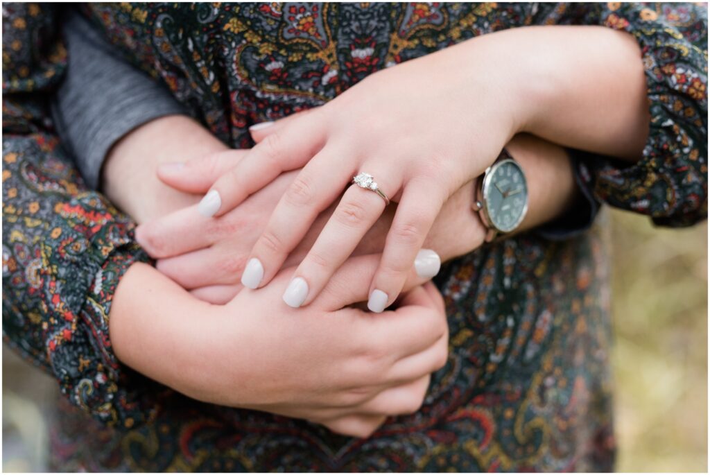 Detail of hands with engagement ring.