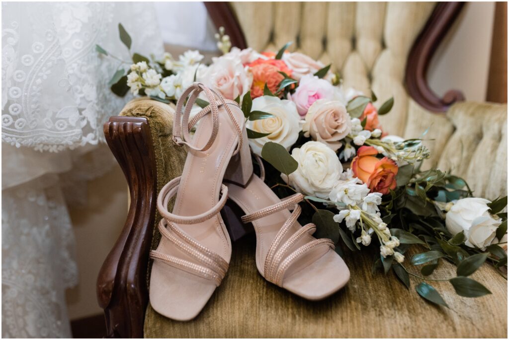Wedding shoes, flowers, and dress at James Mulvey Inn.
