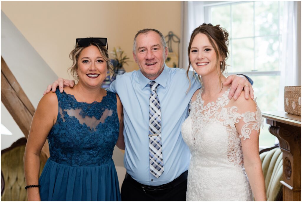 Father of the bride with bride and sister.
