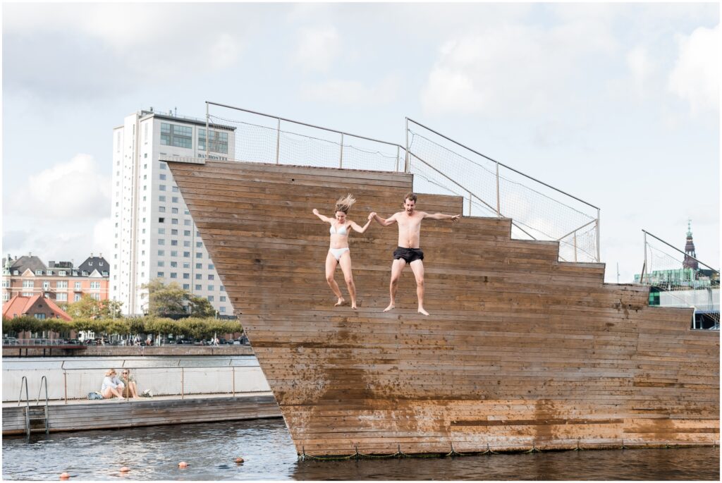 Bride and groom jump in the  Copenhagen Harbour Bath.