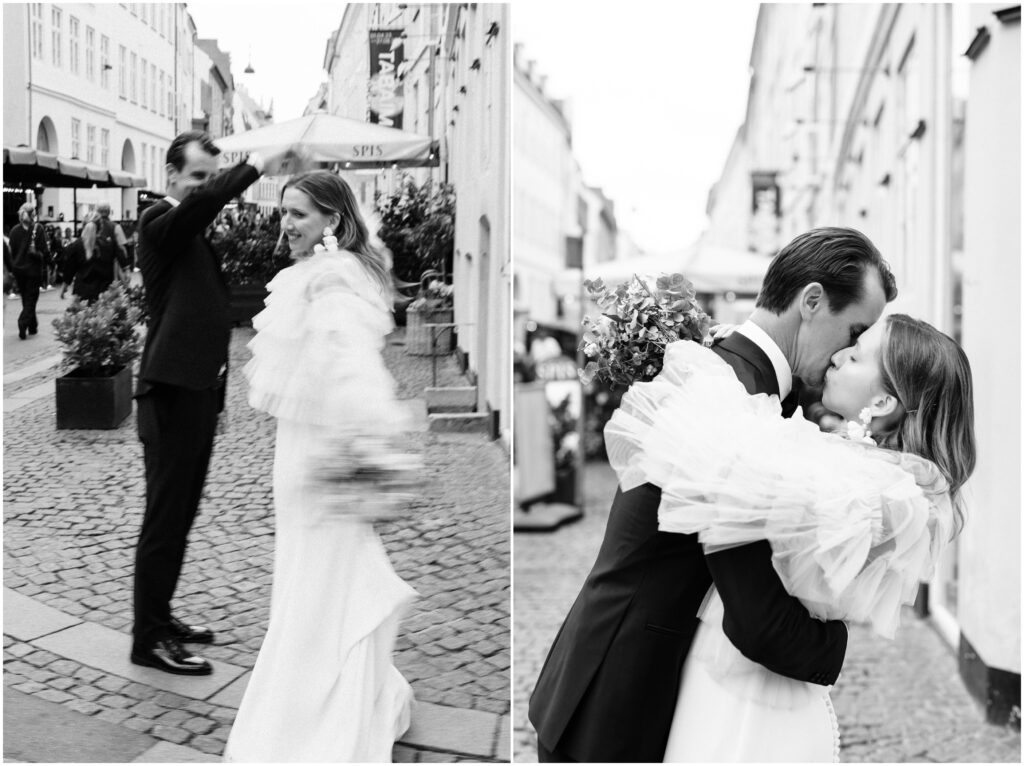 The bride and groom twirl and share a kiss in the center of Copenhagen. 