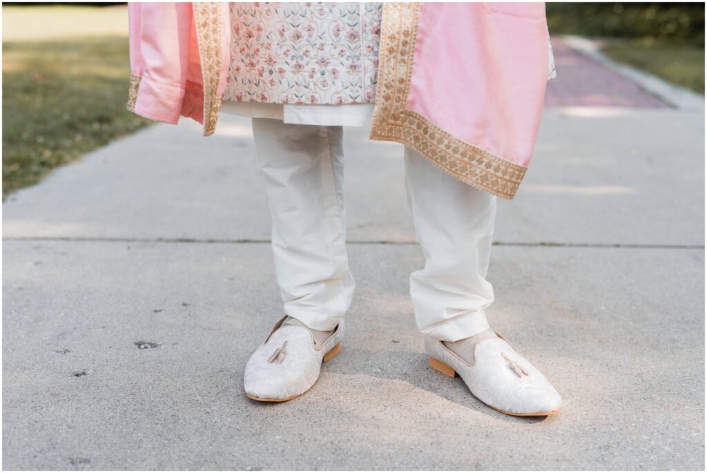 Detail of groom's shoes and his shervani.