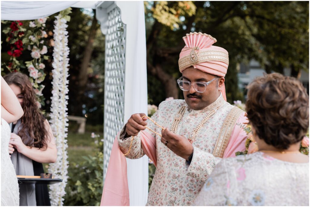 The groom is looking at mangal sultra. 