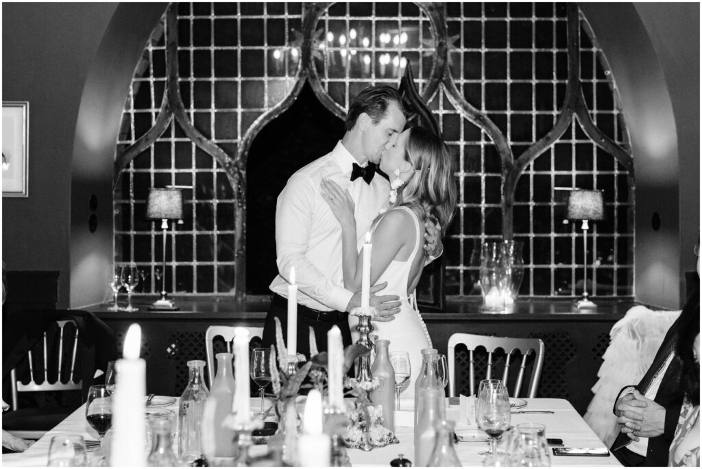 The bride and groom share a kiss at Restaurant Maven during their Copenhagen Elopement 