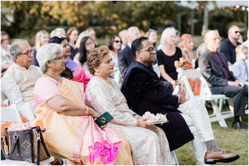 The groom's family watching the wedding ceremony in the first row.