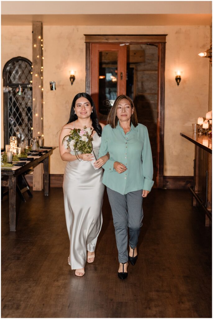 The bride and the mother of the bride walk at Aster Cafe.