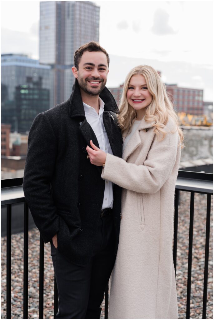 A couple poses on a rooftop downtown Minneapolis.