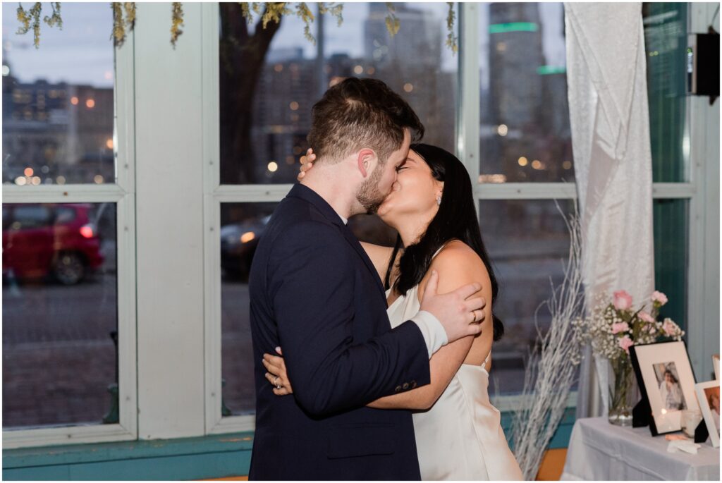 The bride and groom share their first kiss as husband and wife at Aster Cafe in Minneapolis.
