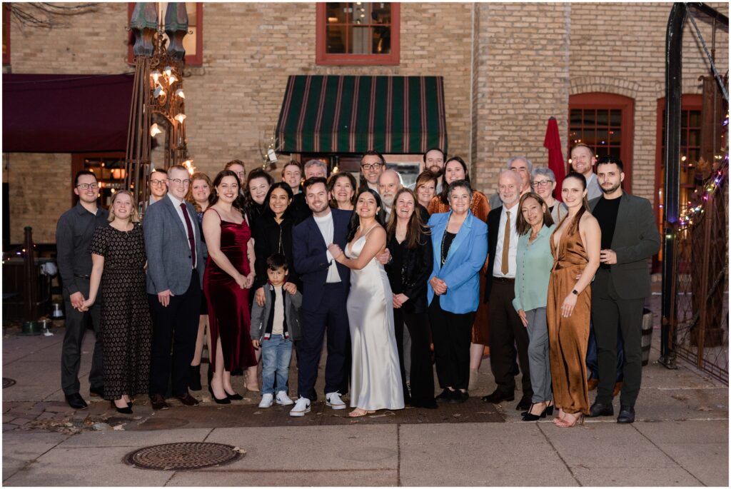 Everyone at the wedding posing outside Aster Cafe in Minneapolis, Minnesota.