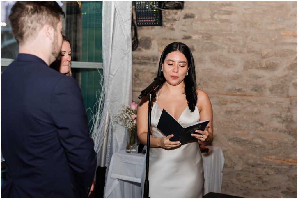 The bride reading her vows during a private wedding at Aster Cafe in Minneapolis.