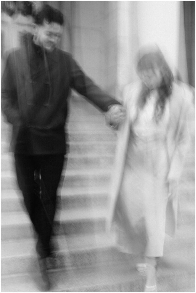 A blurry photo of a couple walking down steps. 