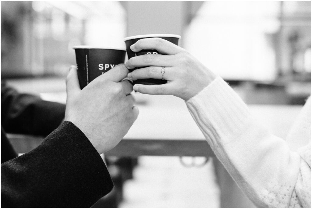 Boyfriend and girlfriend cheers with Spyhouse coffee cups. 