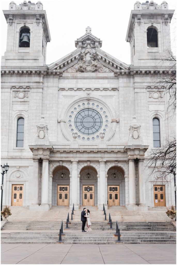 A couple kiss at the Basilica of Saint Mary in Minneapolis, MN.