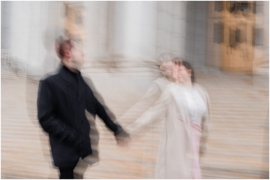 A motion blur photo of a couple walking at the Basilica of Saint Mary.
